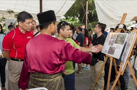 Mr Chan Chun Sing, Minister for Trade and Industry, and Mr Desmond Lee, Minister for Social and Family Development and Second Minister for National Development, looking at a display by the Singapore Heritage Society during Ubin Day 2018.