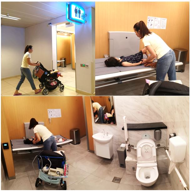 Jasmine and Sarah testing out an accessible changing room with an adult changing table